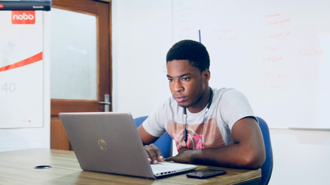 Teacher at a laptop adapting teaching materials to a lower English level