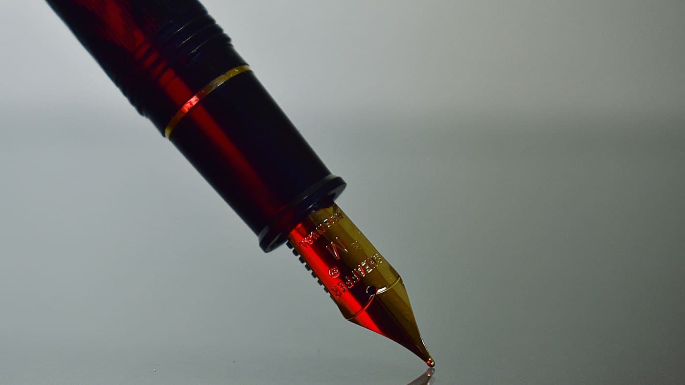 Fountain pen on paper representing CEFR level assessment of English writing