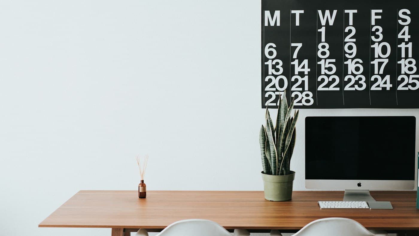 Tidy desk with a computer where an English teacher writes ChatGPT prompts