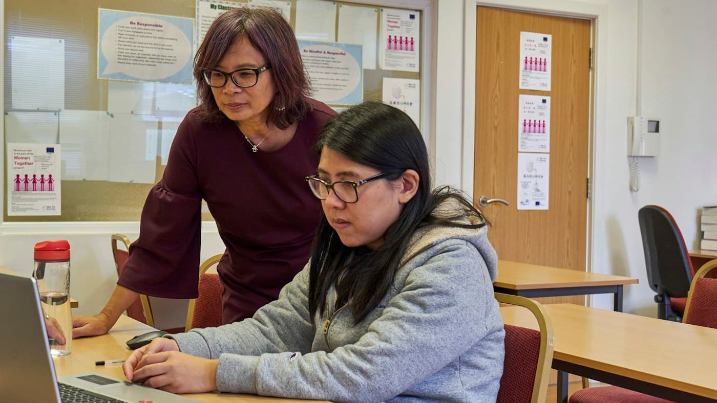 Two teachers reviewing an AI materials tool such as Diffit on a laptop