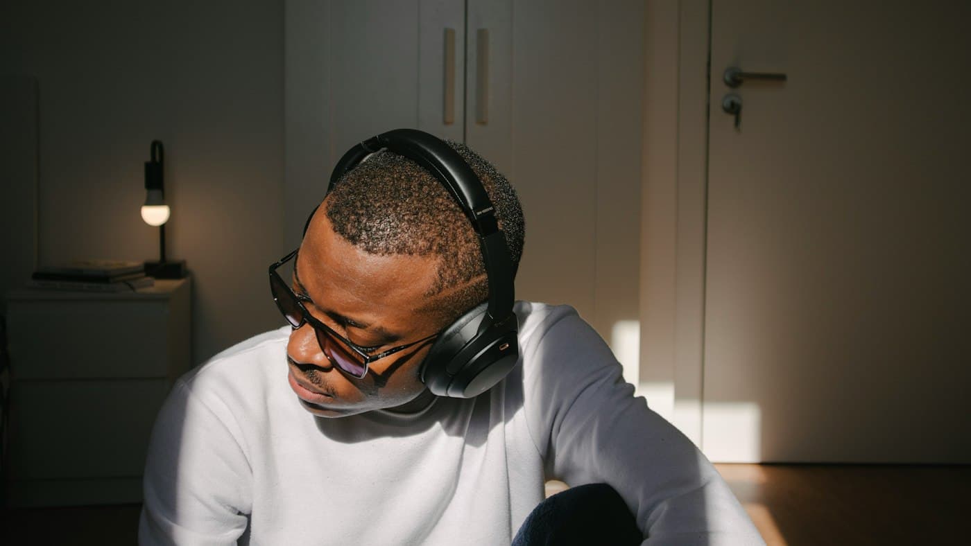 English learner doing ESL listening activities with headphones at a laptop in a quiet room