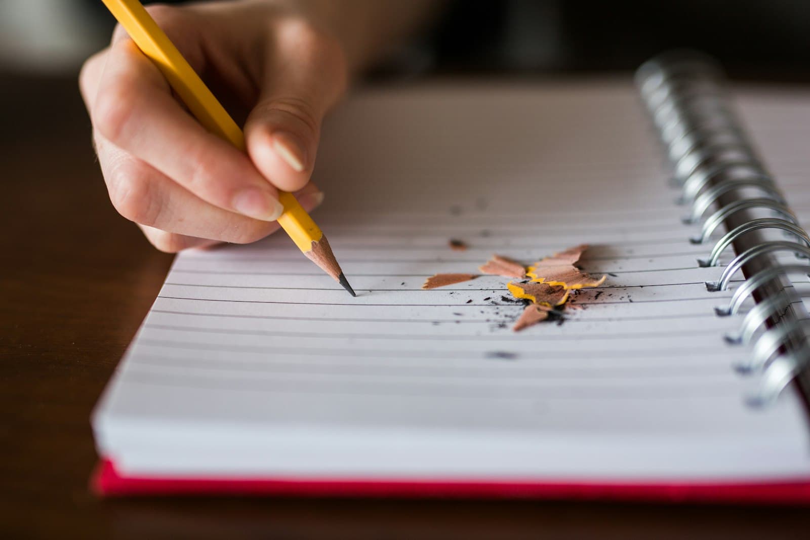 Adult English learner writing by hand in a notebook, where interlanguage errors show up