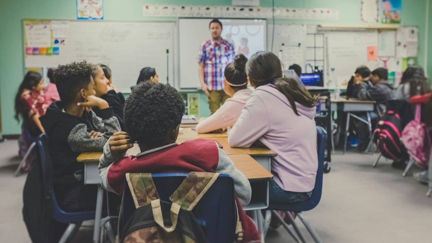 English teacher presenting to adult learners in a classroom using Twee AI lesson materials