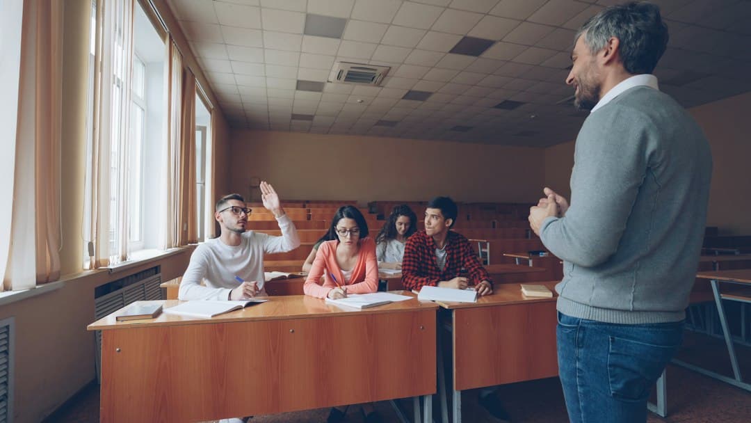 English teacher eliciting answers as a student raises his hand in class