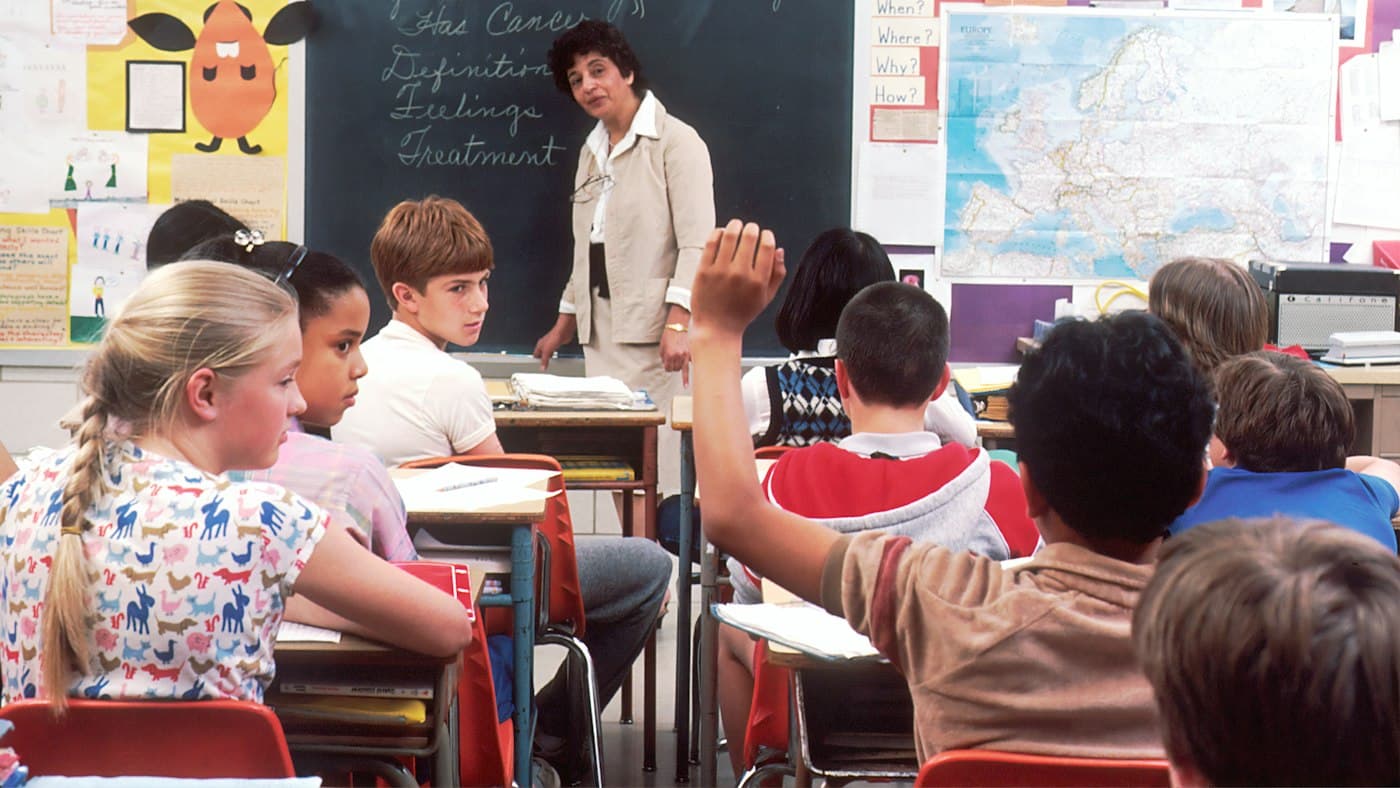 Teacher standing in front of a class while comparing MagicSchool alternatives for English teaching